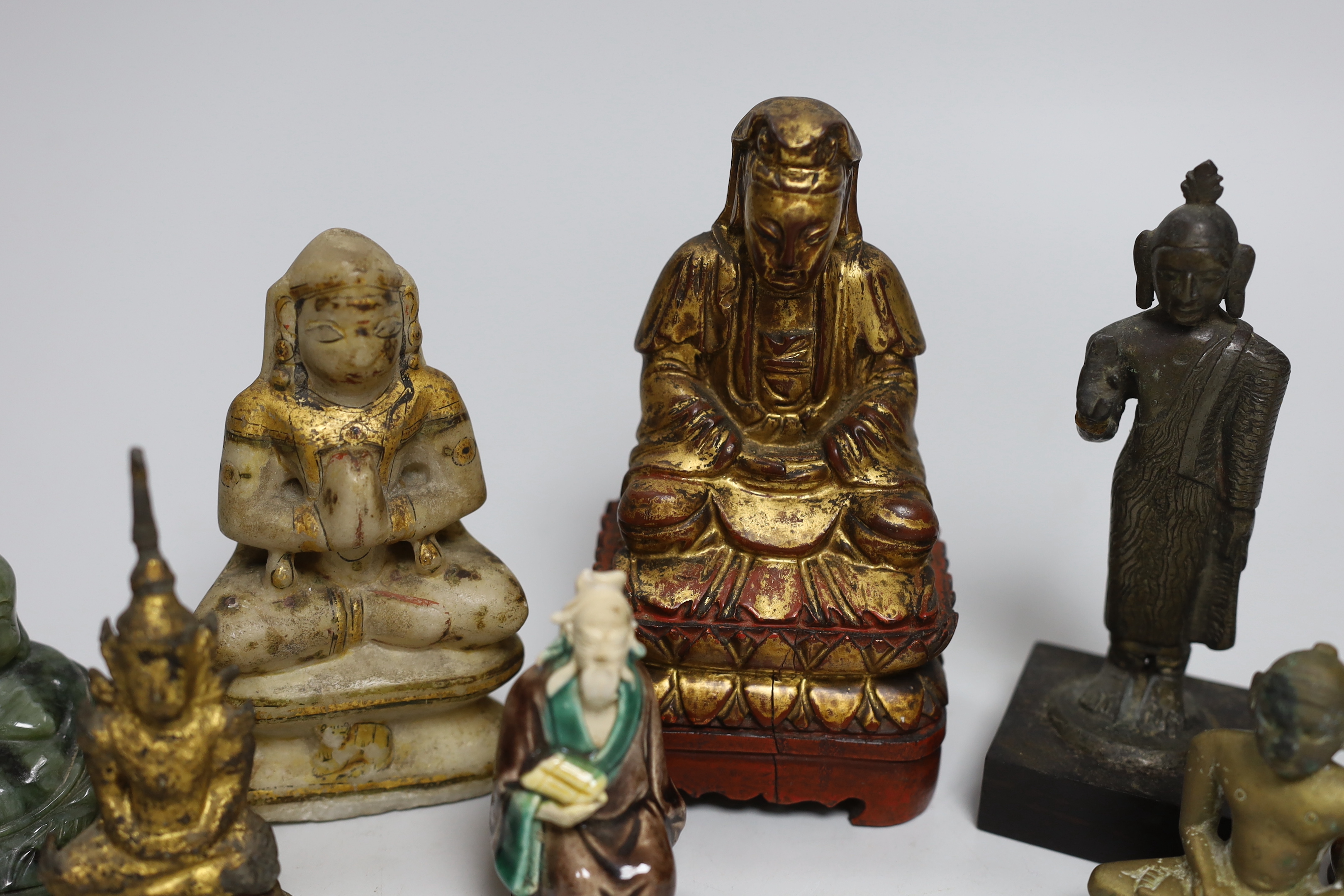 A group of Burmese, Chinese and Indian figures of deities, tallest 14.8cm (8)